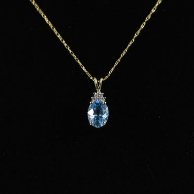 Blue Topaz Oval and Diamond Pendant on Chain in 14K Yellow Gold