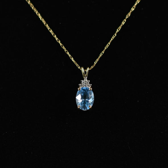 Blue Topaz Oval and Diamond Pendant on Chain in 14K Yellow Gold