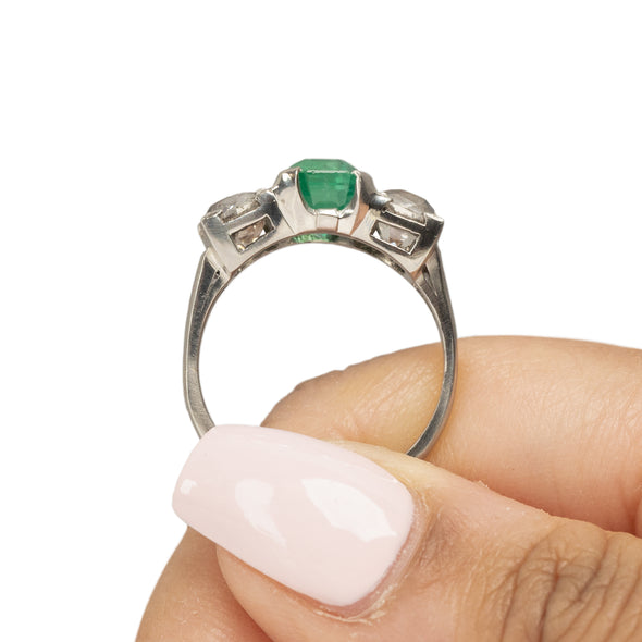 Art Deco Platinum GIA Certified F1 Natural Zambian Emerald and Diamond Three Stone Engagement/Statement Ring in the hand highlighting the overall profile 
