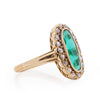 22K Yellow Gold Elongated Vibrant Green Gem with a Diamond Halo from the left showing shank details 