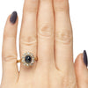 Victorian 14K Yellow Gold Deep Blue Cambodian Cabochon Sapphire and Old European Cut Diamond Halo Cocktail Ring on the hand form the top highlighting the overall look 