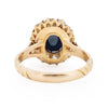 Victorian 14K Yellow Gold Deep Blue Cambodian Cabochon Sapphire and Old European Cut Diamond Halo Cocktail Ring form the bottom peaking under the gallery 