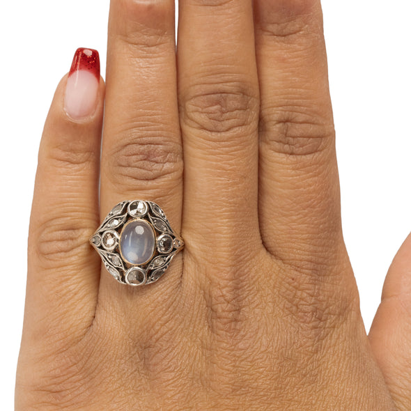 Victorian Sterling Silver and 18K Yellow Gold Vintage Moonstone and Rose Cut Diamond Flora Detailed Statement Ring on the hand from the top showing off the over all shape and look 