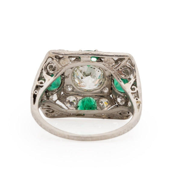 Edwardian Platinum Old Mine Cut Center with Natural Emerald Accents Vintage Statement Ring from the bottom peaking under the gallery 