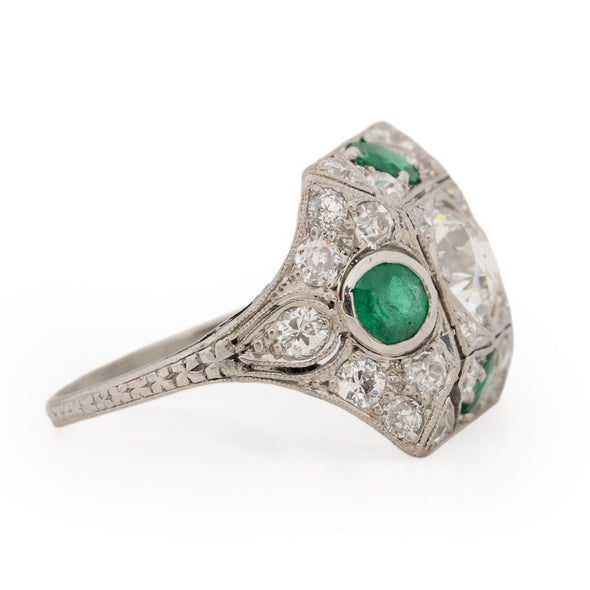 Edwardian Platinum Old Mine Cut Center with Natural Emerald Accents Vintage Statement Ring from the left showing off the carved shanks and diamond details 