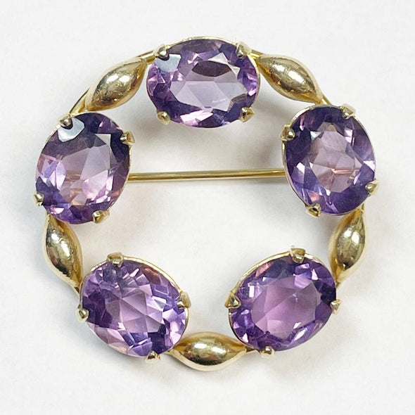 Circa 1930's 14K Yellow Gold Carl Art Circle Amythest Brooch close up highlighting the amethyst facets and overall shape 