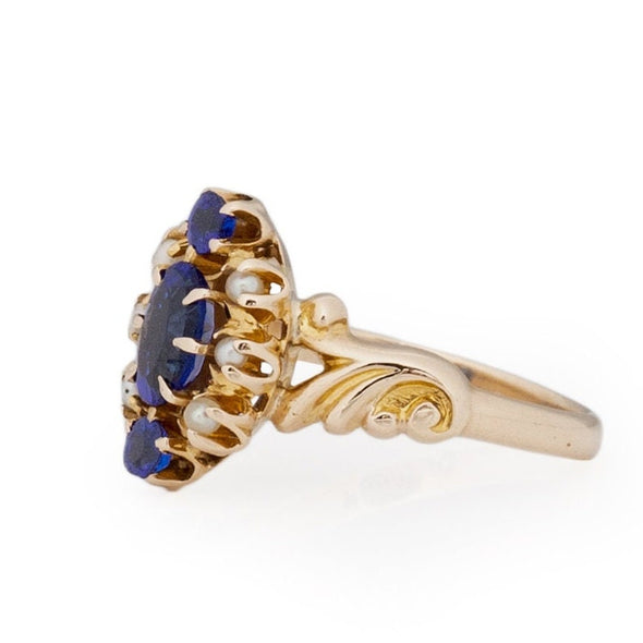 Victorian Style 14K Yellow Gold Deep Blue Gem and Seed Pearl Vintage Fashion Ring with Scroll Work from the right showing off the small split shank details 