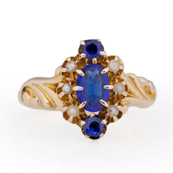 Victorian Style 14K Yellow Gold Deep Blue Gem and Seed Pearl Vintage Fashion Ring with Scroll Work from the front showing off the overall three stone design 