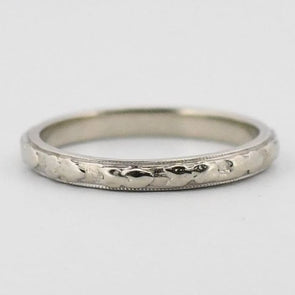 Art Deco 18K White Gold Flower and Milgrain Patterned Stackable Unisex Wedding Band from the front highlighting the carved design 