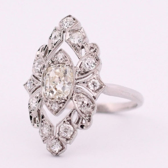 Edwardian Platinum TRAUB Floral 1.02Ct Old Mine Cut Diamond Antique Shield Ring angled to the right show casing the petit milgrain 